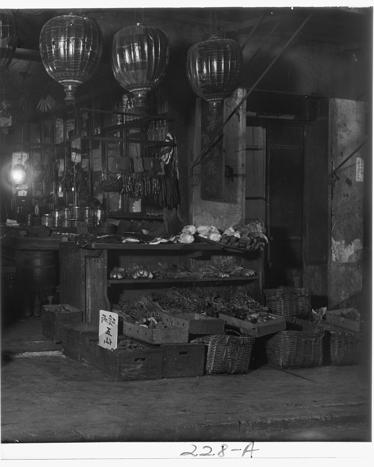 A grocery and herb shop in old San Francisco Chinatown around 1900, with paper lanterns and baskets of goods
